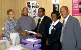 Members of the Bahá’í Community of Botswana present the letter of the Universal House of Justice to leaders of the United Congregational Church in Southern Africa (UCCSA). Shown left to right are: the Reverend Tim Colvin and the Reverend Mosweu Simane of the UCCSA; Dellah Barungwi; Josephine Tsapo; and Lefedile Molefe of the Bahá’í Community of Botswana. The presentation was made at the UCCSA headquarters in Gaborone, Botswana, on 15 May 2002.